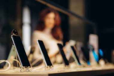  Smartphones store. Showcase with selling various new smartphones in electronics store during a sale. Mobile phone market concept. High quality photo