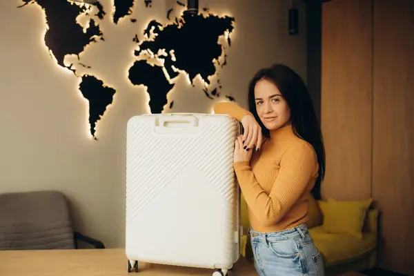 stock image beautiful young woman with a suitcase in a travel agency