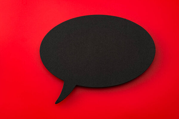 Black Cardboard Cutout of Blank Speech Bubble on Red Background with Copy Space: Concept for Dialogue Design Elements, Expressing Communication Symbols, and Creative Banner Ideas