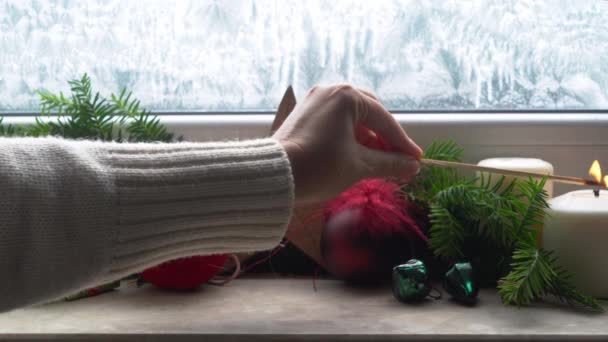 Jemand Zündet Adventskerzen Mit Weihnachtsschmuck Auf Der Fensterbank — Stockvideo
