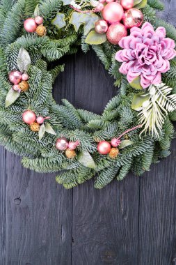 Cristmas wreath garland decorations over dark background