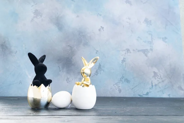 stock image Easter Egg hunt with two Easter rabbits, copy space on gray background