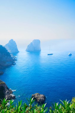 Famous Faraglioni cliffs and Tyrrhenian Sea clear blue water, Capri island, Italy