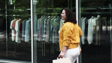 Happy curvy woman with ecologic craft shopping bags enjoying in shopping. Consumerism, shopping, lifestyle concept