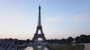 Paris Eiffel Tower at Trocadero gardens at sunrise in Paris, France. Eiffel Tower is one of the most iconic landmarks of Paris with sunshine