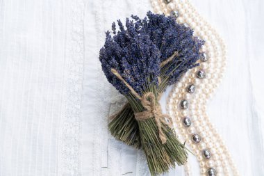 Dry lavender flowers over cloth background with copy space on blank card