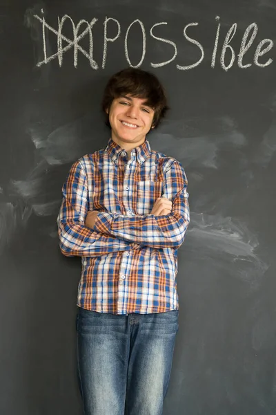 Handsome Teenager Boy Standing Impossible Word Turned Possible Blackboard — Stock Photo, Image
