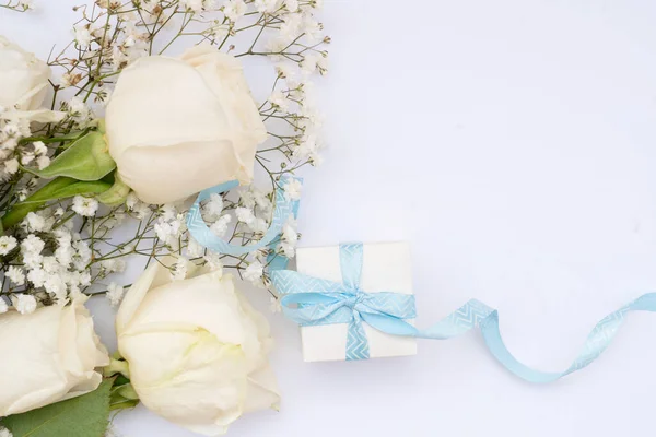 wedding or mothers day background, bouquet with gift box over white background
