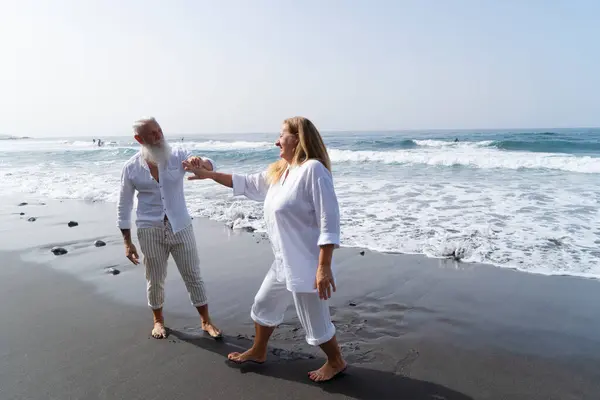 lifestyle of caucasian senior couple dance on beach, happy in love romantic and relax time, tourism of elderly family pleople, leisure and activity travel after retirement in vacations and summer