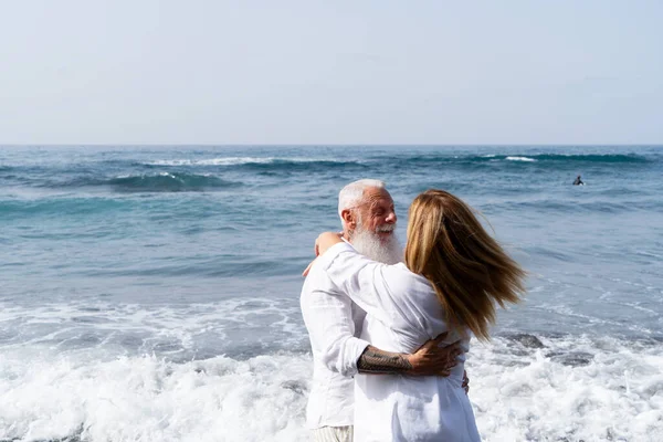 lifestyle with caucasian senior couple dance on beach, happy in love romantic and relax time, tourism of elderly family pleople, leisure and activity travel after retirement in vacations and summer