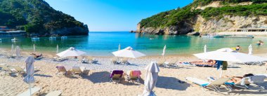 popular beaches of Corfu, panorama of Paleokastritsa beach and Ionian sea on Korfu, Greece clipart