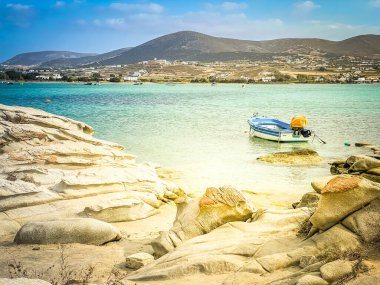 Romantic beach with rocks at greek island, Paros Greece with sunshine, panorama web format clipart