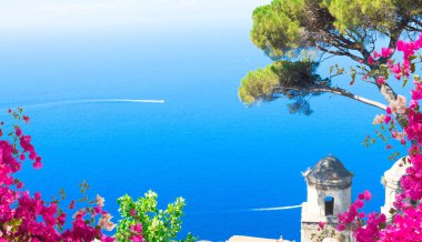 Belltower in Ravello village with sea view with flowers, Amalfi coast of Italy