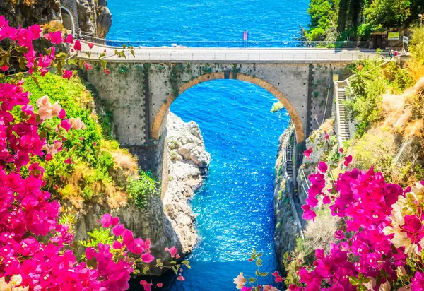 famous picturesque road viaduct over sea of Amalfi coast with flowers, Italy