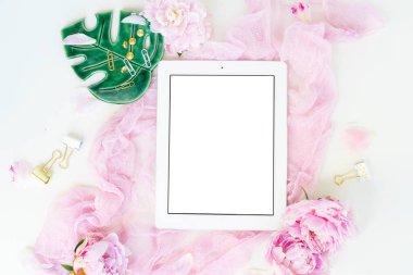 Tablet çerçeveli yaratıcı düğün kompozisyonu, pembe battaniye, beyaz arka planda çiçekler. Düz yatış, üst görünüm stil sanat kavramı.