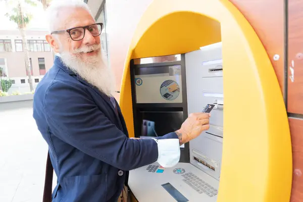 Senior man with ATM, Happy mature male using bank cash machine - Concept of business, banking account and lifestyle people