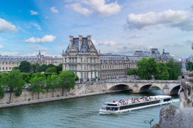 Pris cityscape with Louvre, boat and river Siene at summer, Paris, France clipart