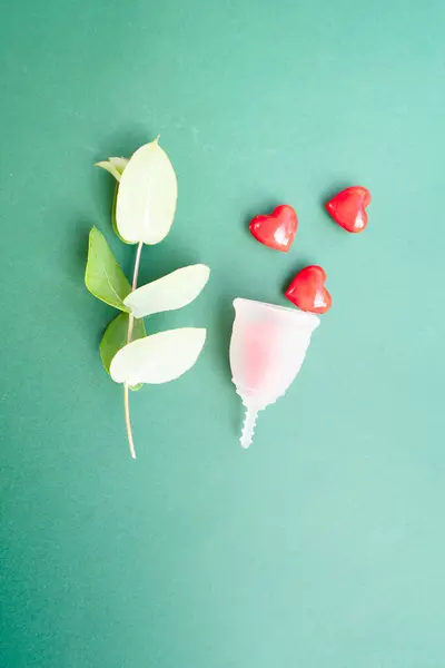 stock image Menstrual cup over green background, eco friendly and zero waste solution