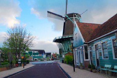 rural dutch country skyline with traditional windmill of small old town Zaanse Schans at sunset, Netherlands clipart