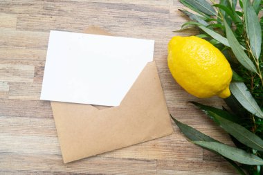 Happy Sukkot - religion image of Jewish festival of Sukkot. Traditional symbols Etrog, lulav, hadas, arava on wooden table with thank you note and copy space on white card