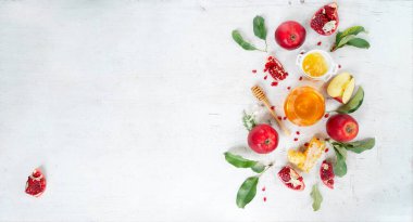 rosh hashana holiday - honey with apple and pomergranate over white desk, festive background with copy space