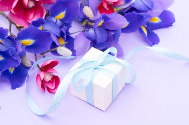 Orkideli taze iris çiçekleri, hediye kutusu, kopya alanı olan bahar arkaplanı