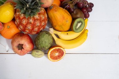 Beyaz ahşap arka planda tropikal meyvelerin yaz karışımı