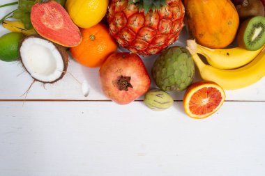 Beyaz ahşap arka planda tropikal meyvelerin yaz karışımı