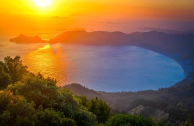 Korfu 'nun popüler plajları. Günbatımında Corfu adasındaki Agios Georgios Pagon plajında inanılmaz manzara, Yunanistan