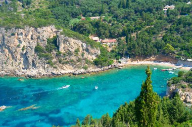 Paleokastritsa beach bay with sunbeds and Ionian sea clear water on Korfu, Greece
