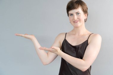 Gri arka planda yaşayan mutlu genç kız.