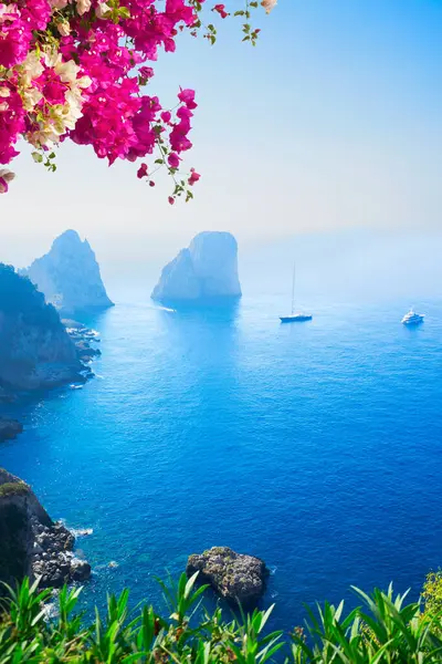 Famous Faraglioni cliffs and Tyrrhenian Sea clear blue water, Capri island, Italy