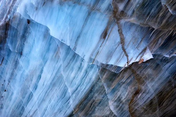 Beautiful landscape of Blue ice cave wall texture at mountains against blue sky in Almaty, Kazakhstan