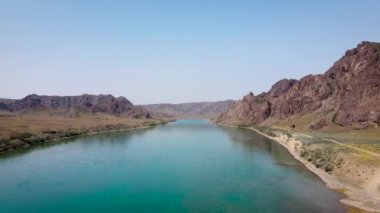 İHA, güney Kazakistan 'da gün batımında Ili nehri ve bahar bozkırlarını görüntüledi. Güzel doğa manzarası