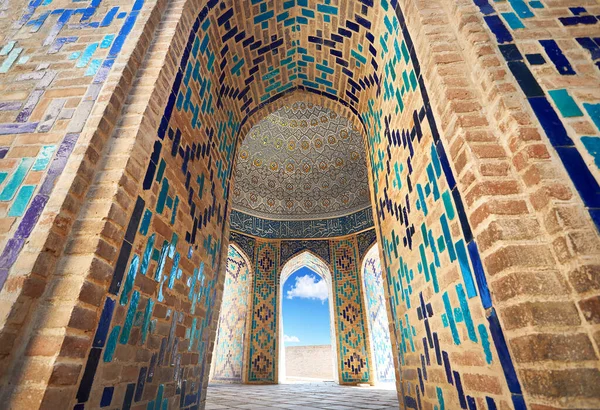 Beautiful Arch entrance of Historical cemetery of Shahi Zinda with finely decorated by blue and turquoise stone mosaic mausoleums in Samarkand, Uzbekistan.