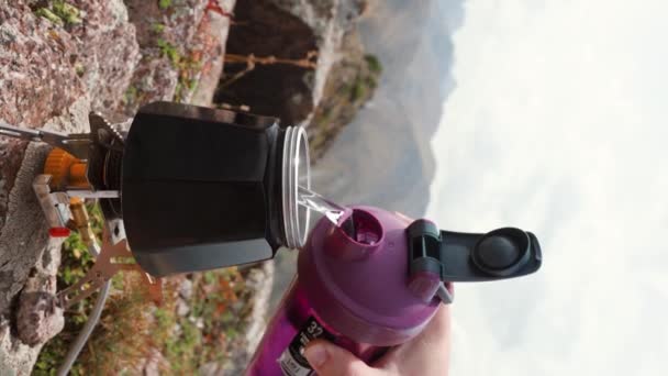 Turistin Şişeden Siyah Moka Demliğine Döktüğü Dikey Video Dağ Kampında — Stok video