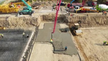 Kırmızı vinç ve işçi vakfından dökülen Beton mikserin havadan drone görüntüsü..
