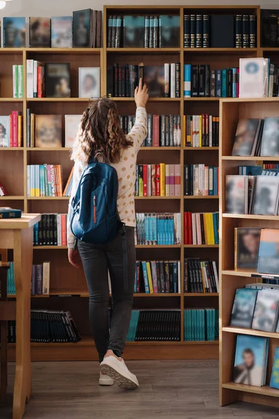 Teen Girl Pile Books Young Girl Holding Books Shelves Background — Stockfoto