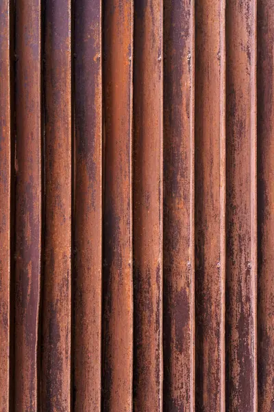 Warm-toned rusty corrugated iron sheet, perfect for creating grunge backgrounds and textured overlays in designs