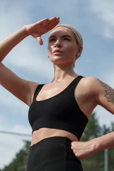 Focused Athletic Woman Tattoos Taking Break Shielding Eyes Sun Outdoor Stock Photo