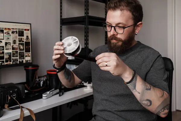 Focused Male Photographer Reviews Film Negatives His Workspace Filled Photography Stock Picture