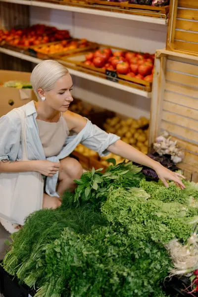 Young Woman Carefully Selects Fresh Greens Well Stocked Grocery Store Stock Photo