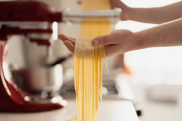 Close Hands Cutting Fresh Pasta Dough Using Kitchen Appliance Royalty Free Εικόνες Αρχείου