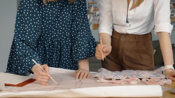 Two Fashion Designers Working Together Studio Table Drawing Discussing Patterns — Stock Video
