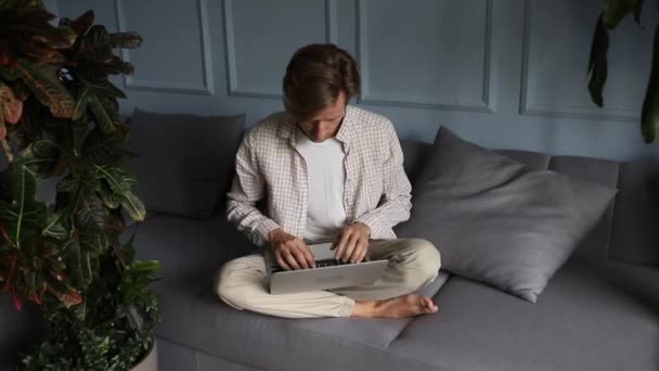 Young Man Millennial Entrepreneur Sitting Sofa Working Laptop Computer Portrait — Vídeo de stock