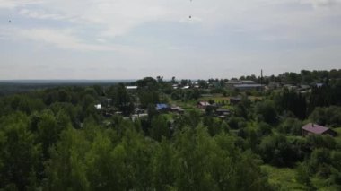 Kirov bölgesindeki küçük bir kasaba olan Nagorsk 'ta yeşil yüksek ağaçlı engin bir ormanın ortasındaki yerleşim yerlerinin Dron manzarası.