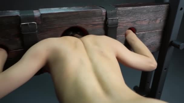 Back View Topless Lady Sitting Bondage Bench Bdsm Game Grey — Stock Video