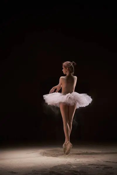 Topless Young Ballerina White Skirt Standing Pointe Sandy Dance Class 图库图片
