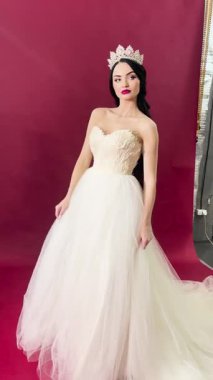 Çekici bir gelin, zarif ve zarif bir elbiseyle özel gününe hazırlanır..