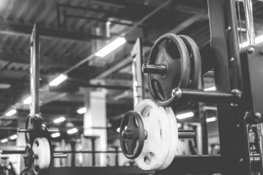Modern bir spor salonunda ağırlıklar, siyah-beyaz atış